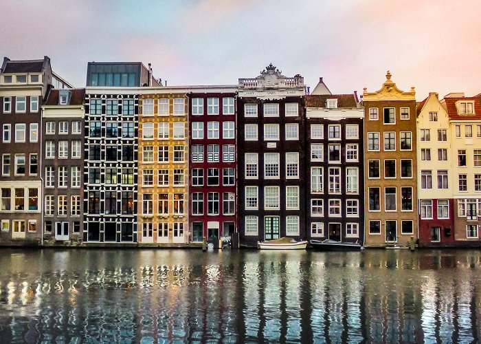 Damrak Exploring Amsterdam at Sunrise | Postcards from a Wide World photo