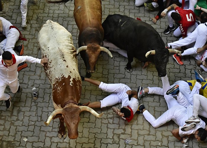 Spanish Red Cross Three runners are gored in a tense 5th Pamplona bull run : NPR photo