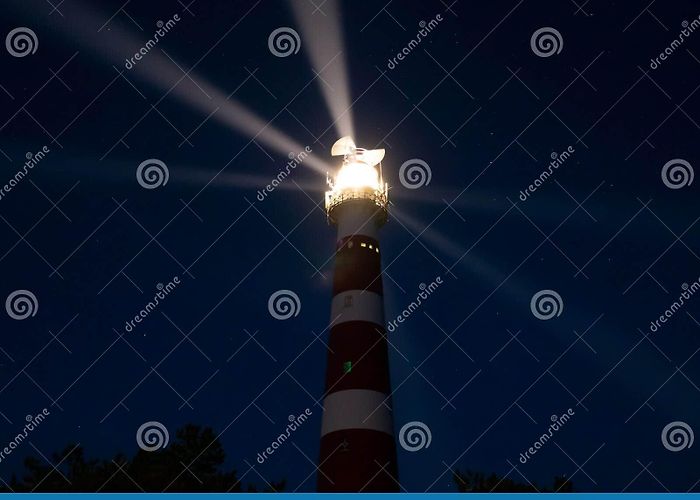 Lighthouse Ameland Lighthouse with Light Rays during Night on the Island of Ameland ... photo